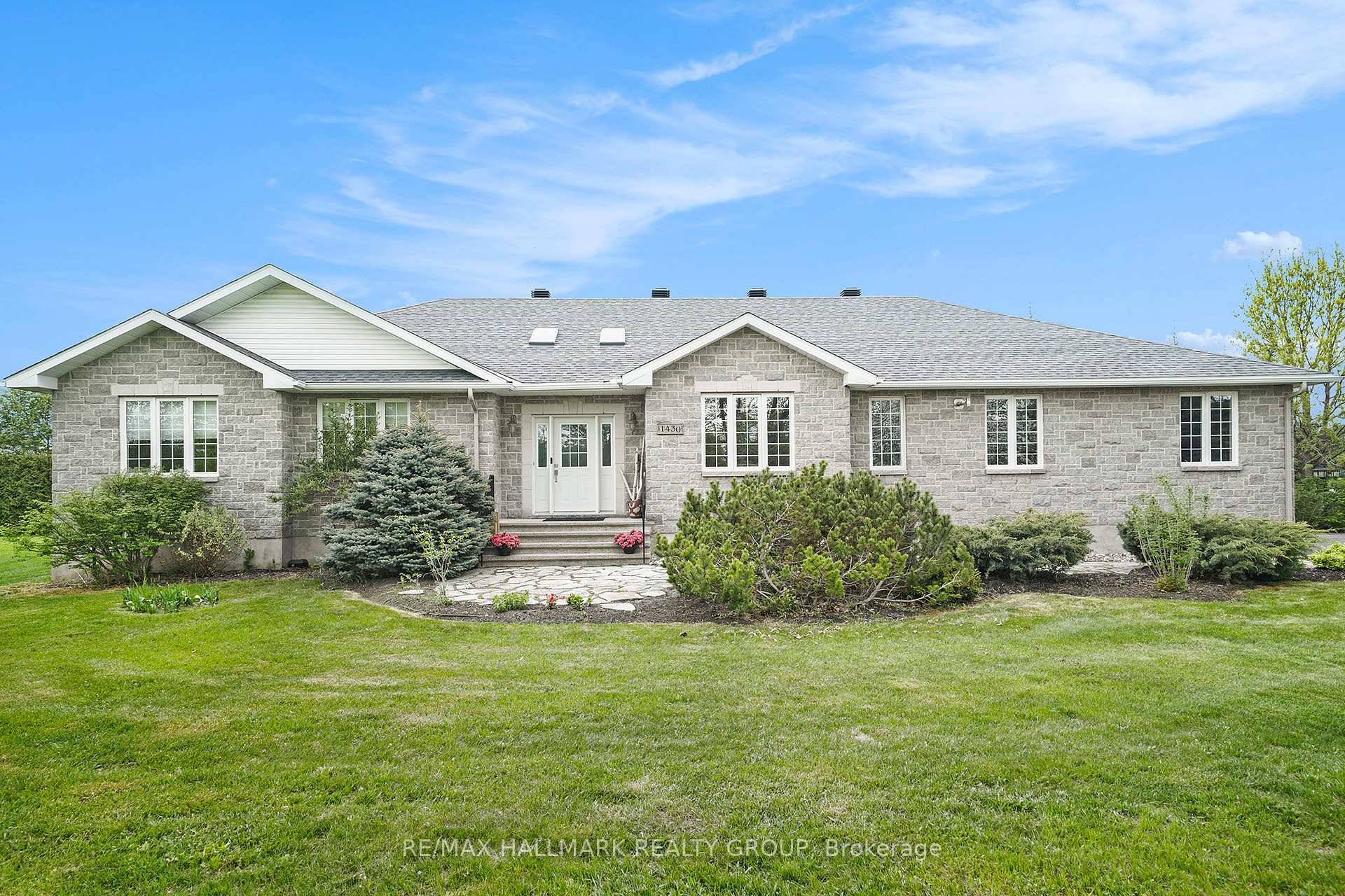 Welcome to this custom built stone bungalow, a true gem nestled in a serene setting with accessory apartment income potential.