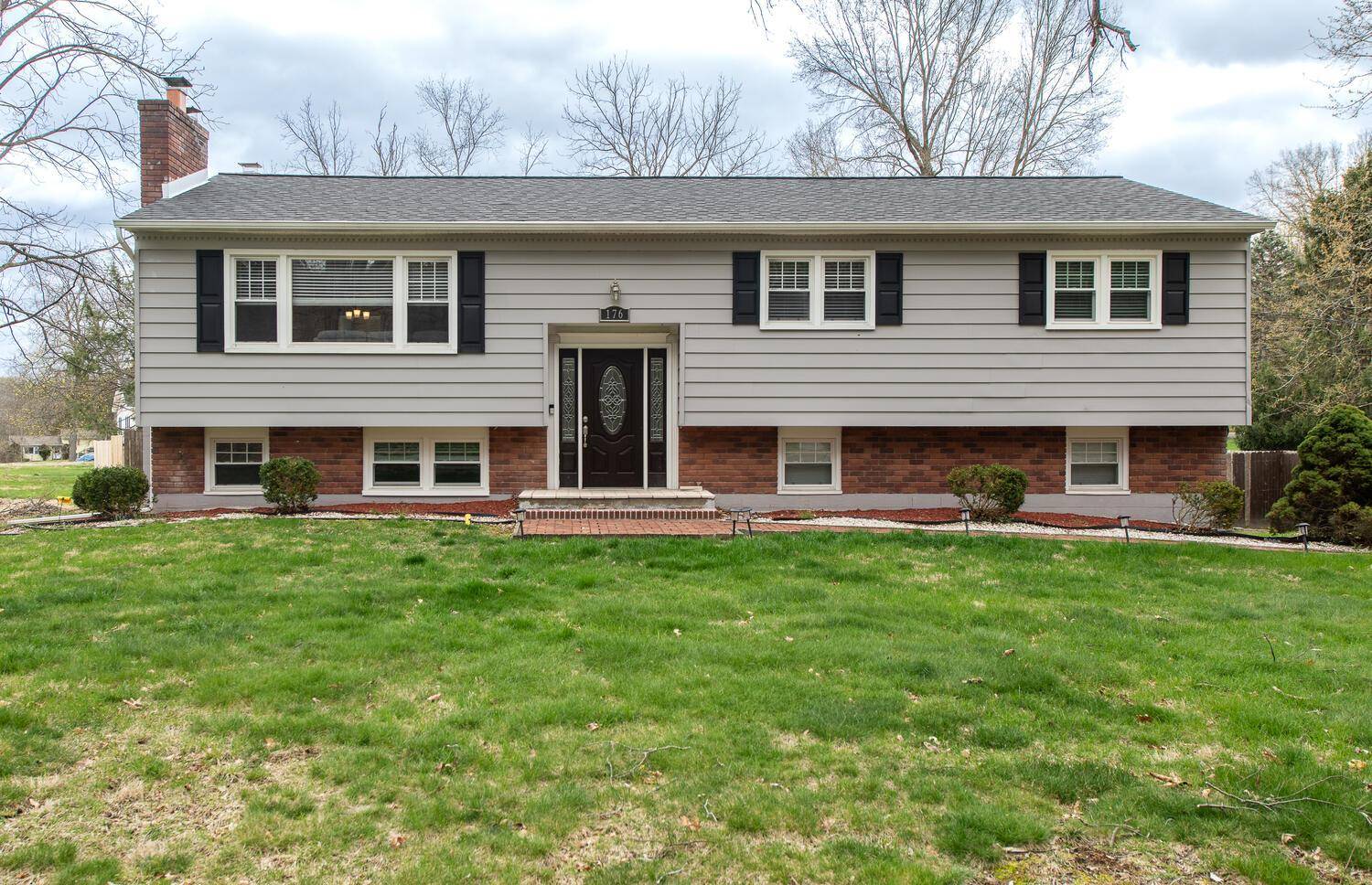 Set back from the road, buffered by a row of mature trees, sits this handsome, spacious home.