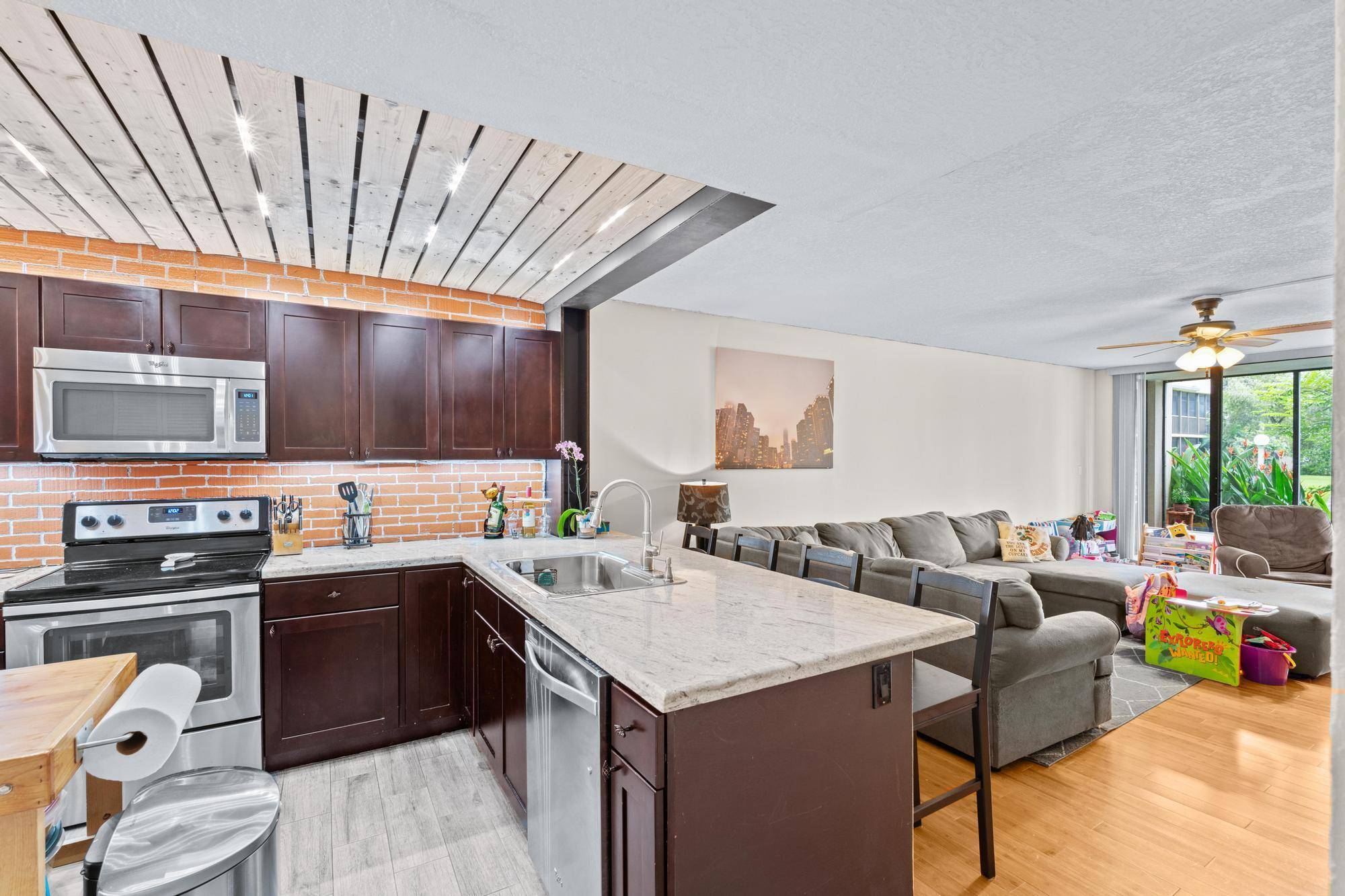 INVESTOR DEAL ! This 2 2 first floor unit boots a large kitchen with island upgraded with stainless steel appliances as well as custom lighting feature.