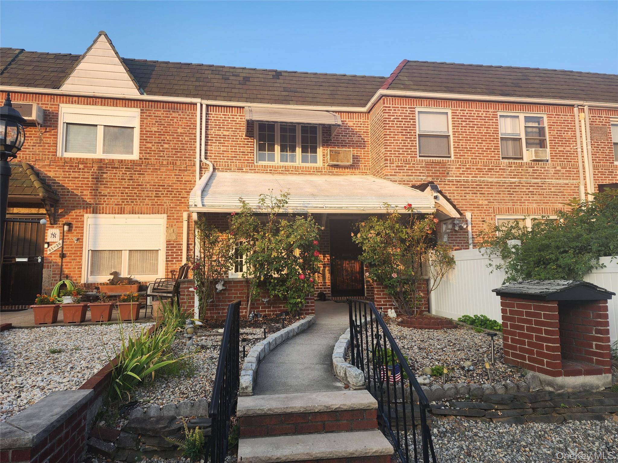 Welcome to this charming single family brick townhouse in Middle Village with 1 car garage, located only 1 block to Juniper Park.