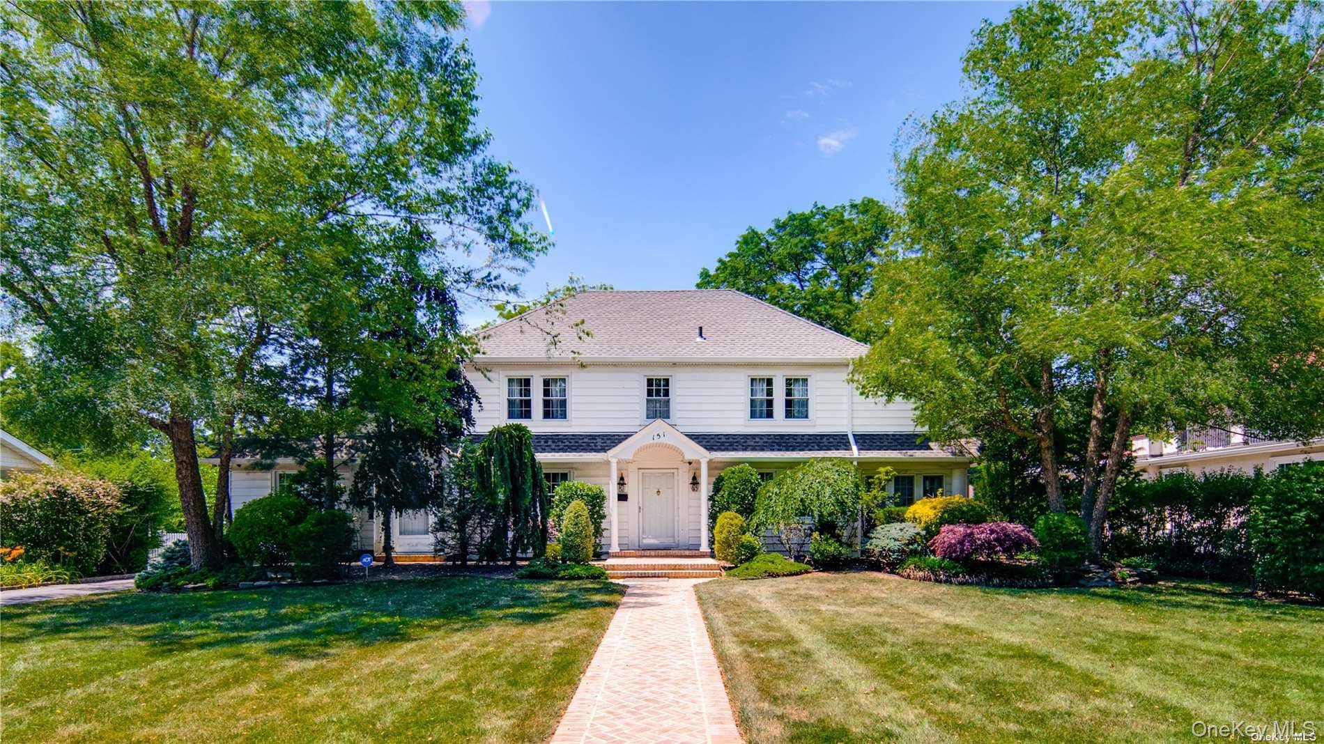 Welcome to this Classic Center Hall Colonial, nestled in the picturesque neighborhood of Cathedral Gardens.