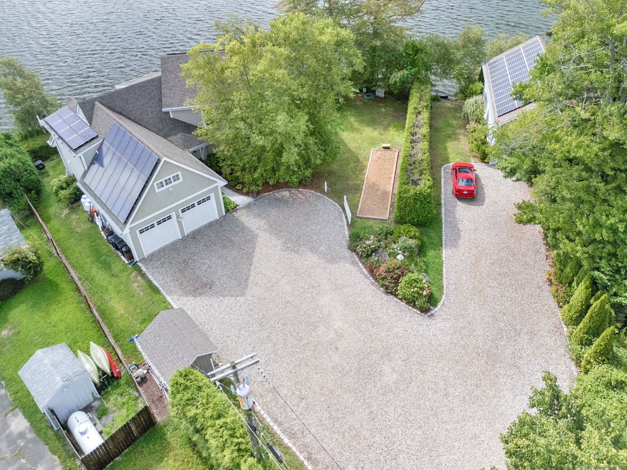 Escape to a tranquil lakefront retreat at Lake Pocotopaug featuring a spectacular Lake House charming Cottage.