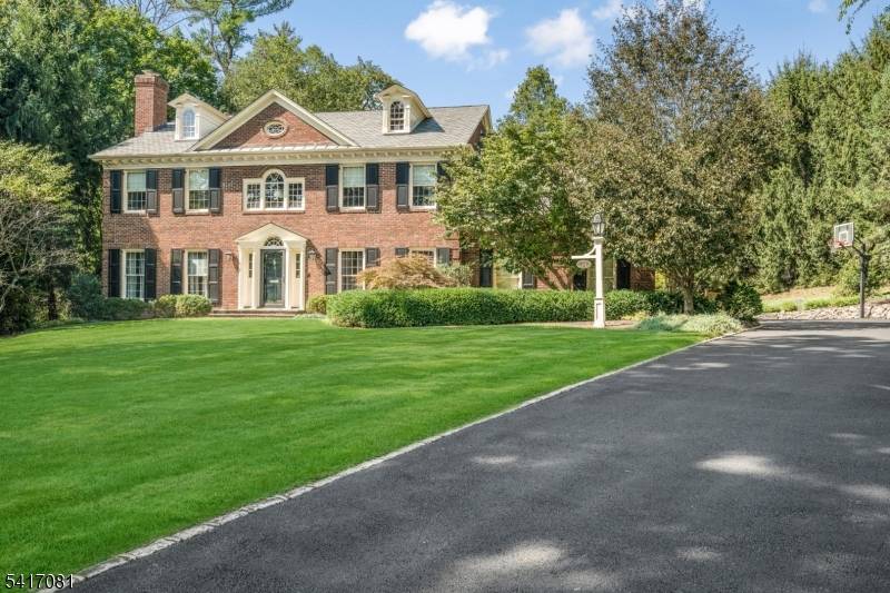 Set back from the street with a long tree lined approach, this timeless Georgian brick Colonial makes an immediate impression with its symmetry, scale and quiet confidence.