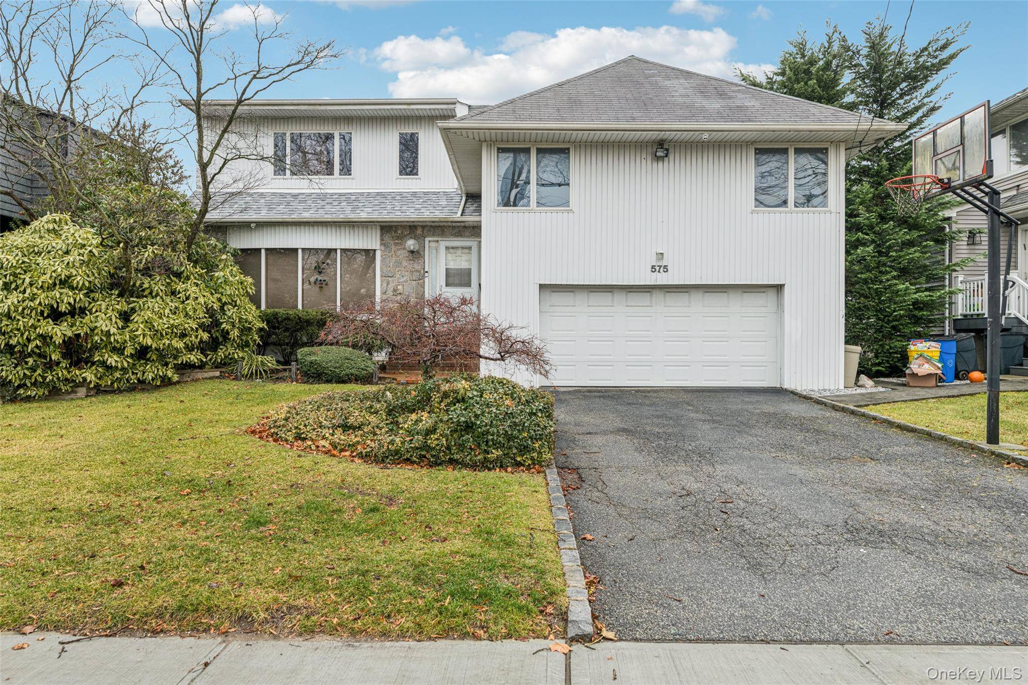 Welcome to this beautifully maintained 5 bedroom, 4 bathroom home in the heart of Woodmere.