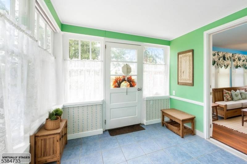 Welcome Charming Cape Cod timeless character, cozy covered front porch, leads to the great room, beautiful beamed ceilings, stunning stone fireplace, a perfect place for gatherings.