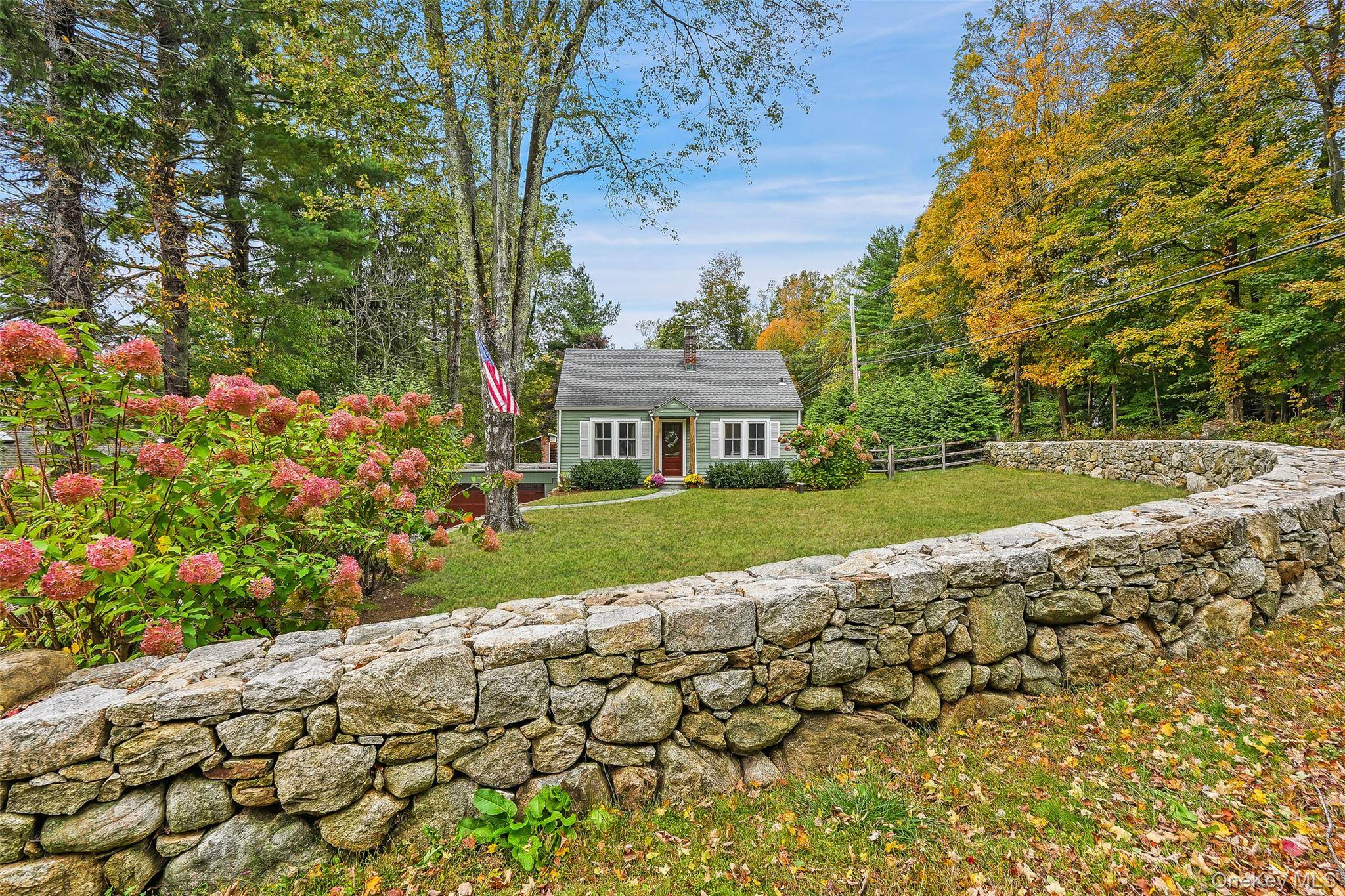 Welcome home to 37 East Street, where charm and effortless living come together on a storybook corner lot in the heart of South Salem.