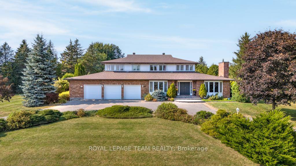 Nestled on a private, one acre lot, this classic brick estate offers refined living in the prestigious Cedar Hill Golf and Country Club community.