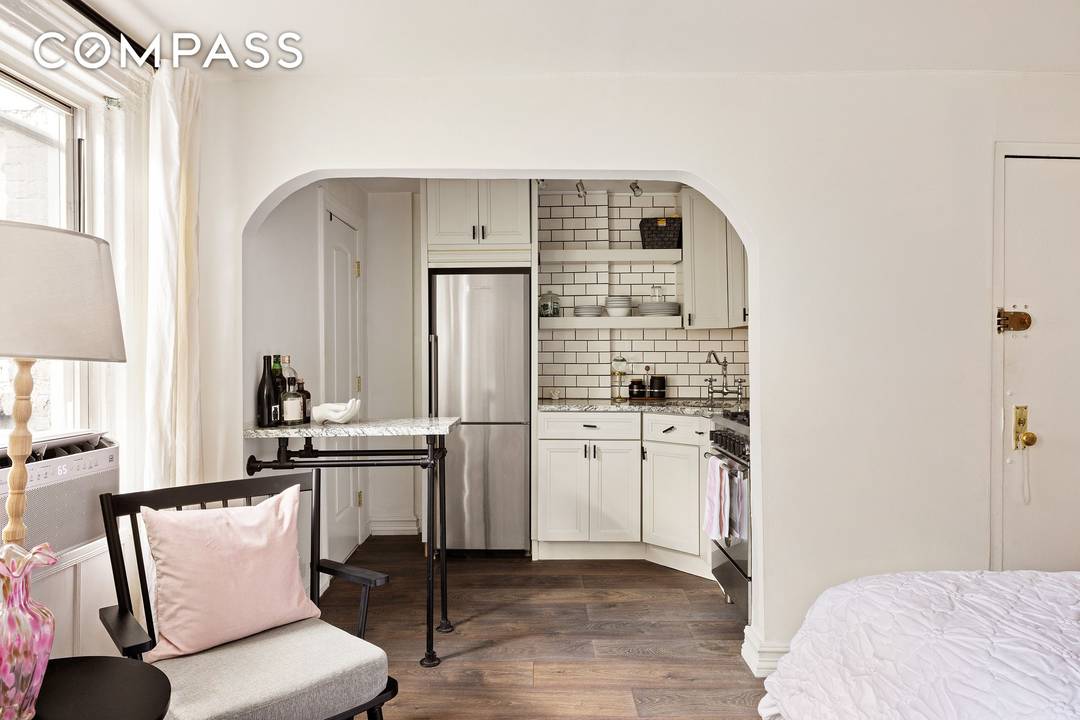 Tucked on a tree lined block of Perry Street, this charming pre war studio has all the romance a white brick fireplace, wide plank hardwood floors, an arched doorway, and ...