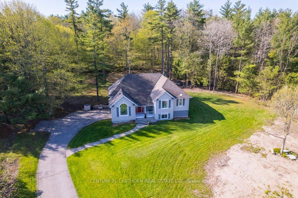 Welcome to 71 Waddingham Road, Tyendinaga a beautifully appointed raised bungalow tucked away on a serene country lot, surrounded by a lush canopy of mature trees.