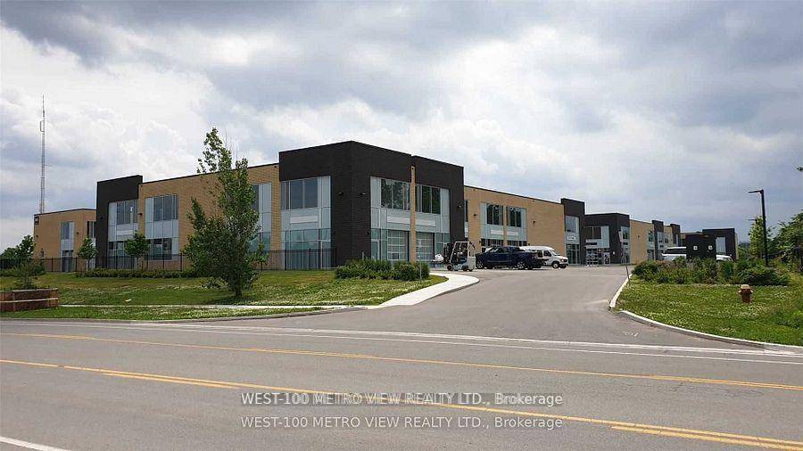 Modern bright commercial industrial condo unit with front glass drive in ground shipping door, aluminum frame windows, 22 ft clear height, zoning permits a wide range of uses, parking available, ...