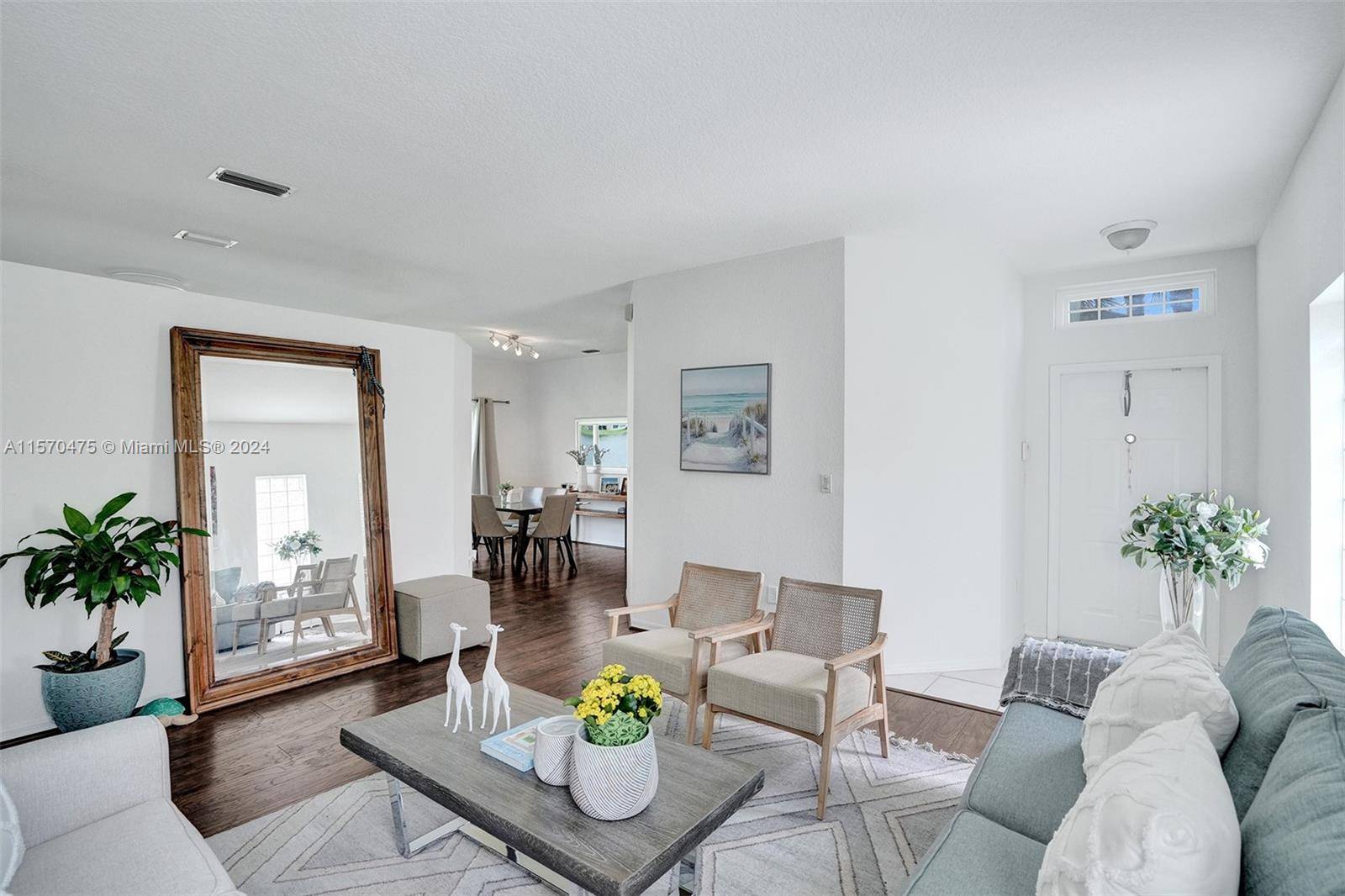 Bright 1 story lake view home in gated community of Emerald Estates in Weston.