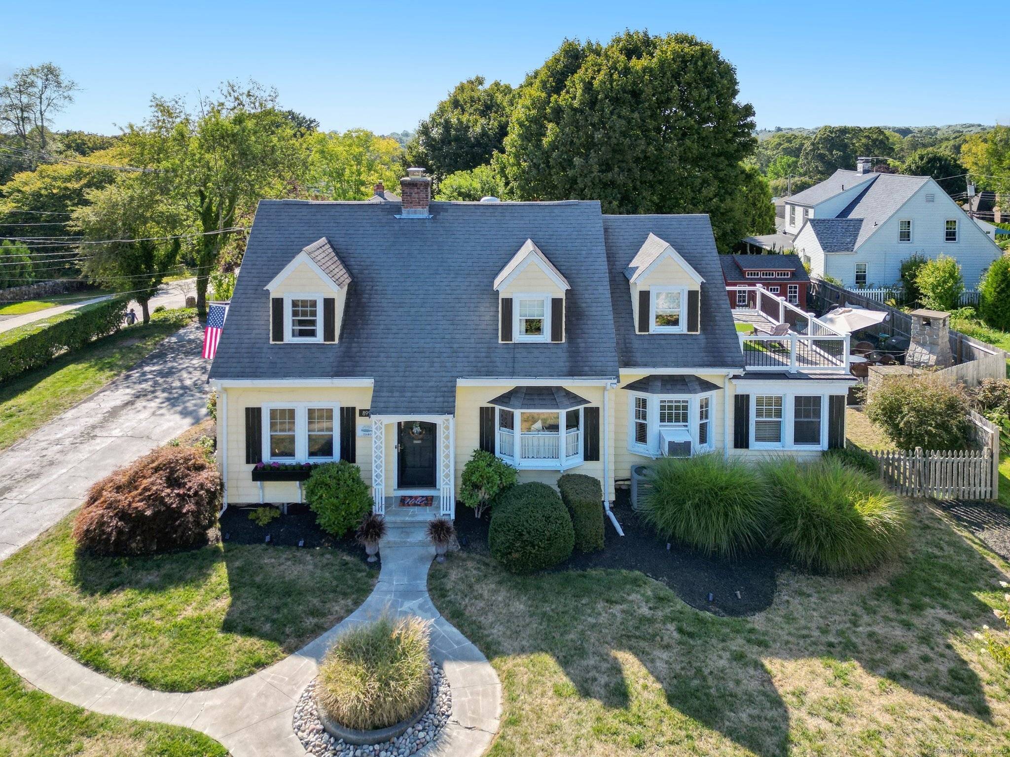 This beautifully remodeled 1928 yellow Cape Cod offers charm, comfort, and versatility.