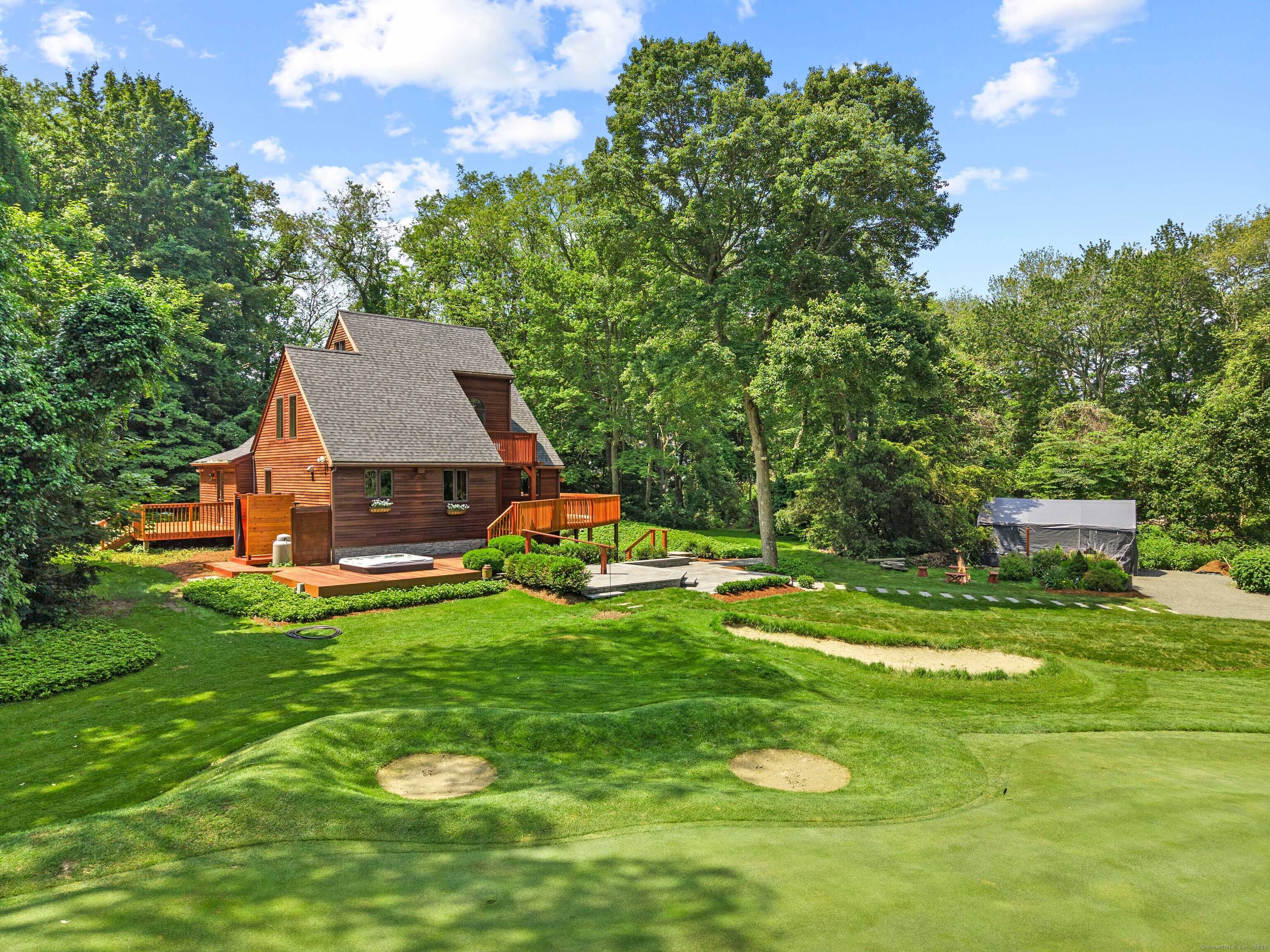 A boater's dream with a private marina with direct access to Long Island Sound along with Indiantown beach rights, and a private practice golf green at your doorstep.