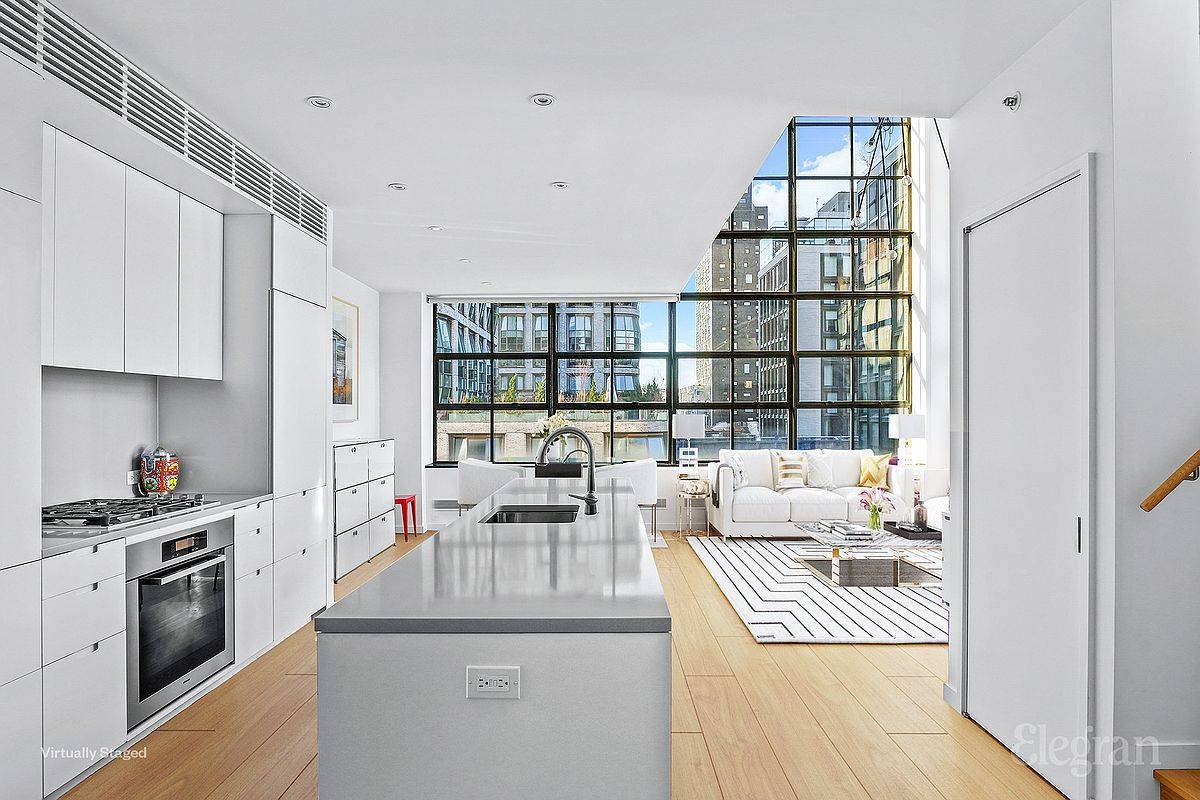 The distinctive charm of this corner duplex begins with its impressive 20ft double height ceilings.