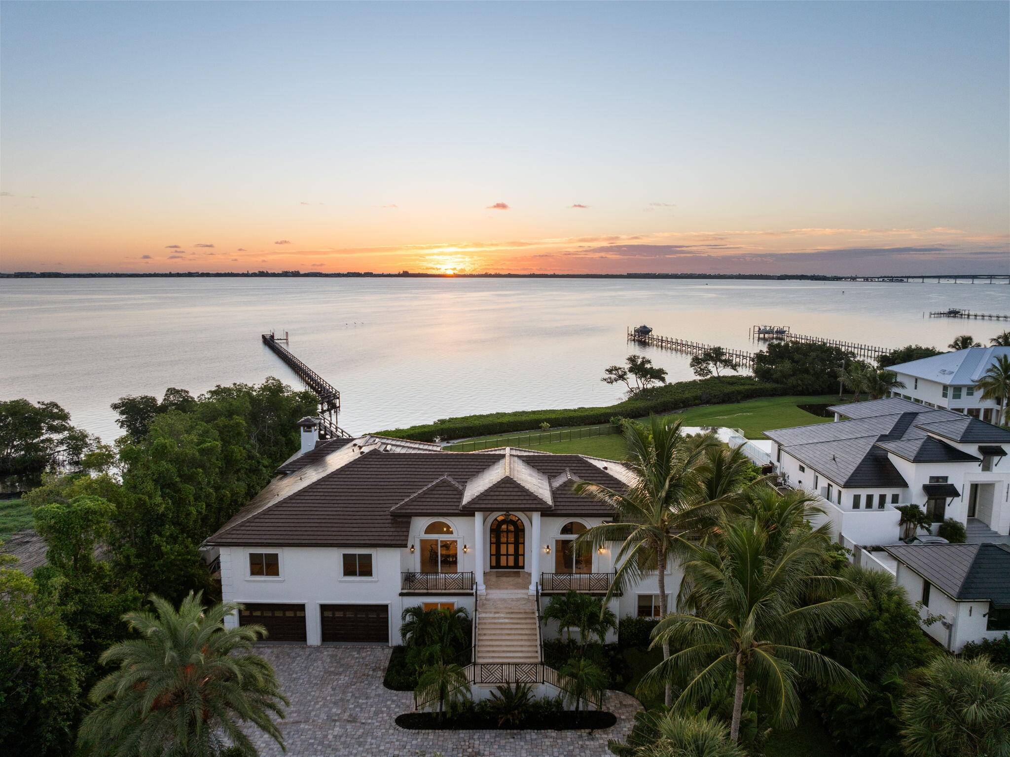 Offered fully furnished sold turnkey, this gated Sewalls Point estate was completely gutted reimagined in 2022 with hand selected materials by FireFinish Interiors additional bespoke finishes by Hurd Homes.