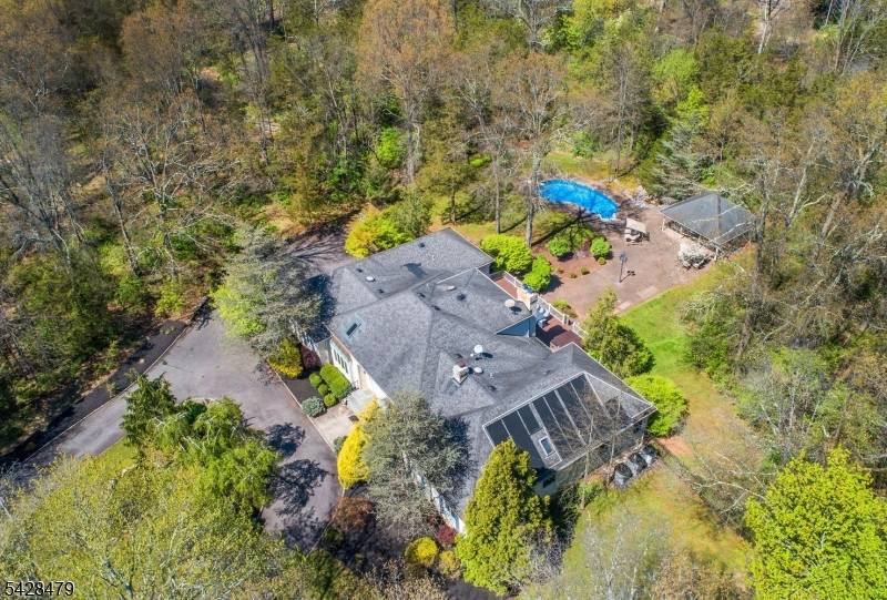 Set on 9 private acres, this exceptional 5 bedroom, 4.
