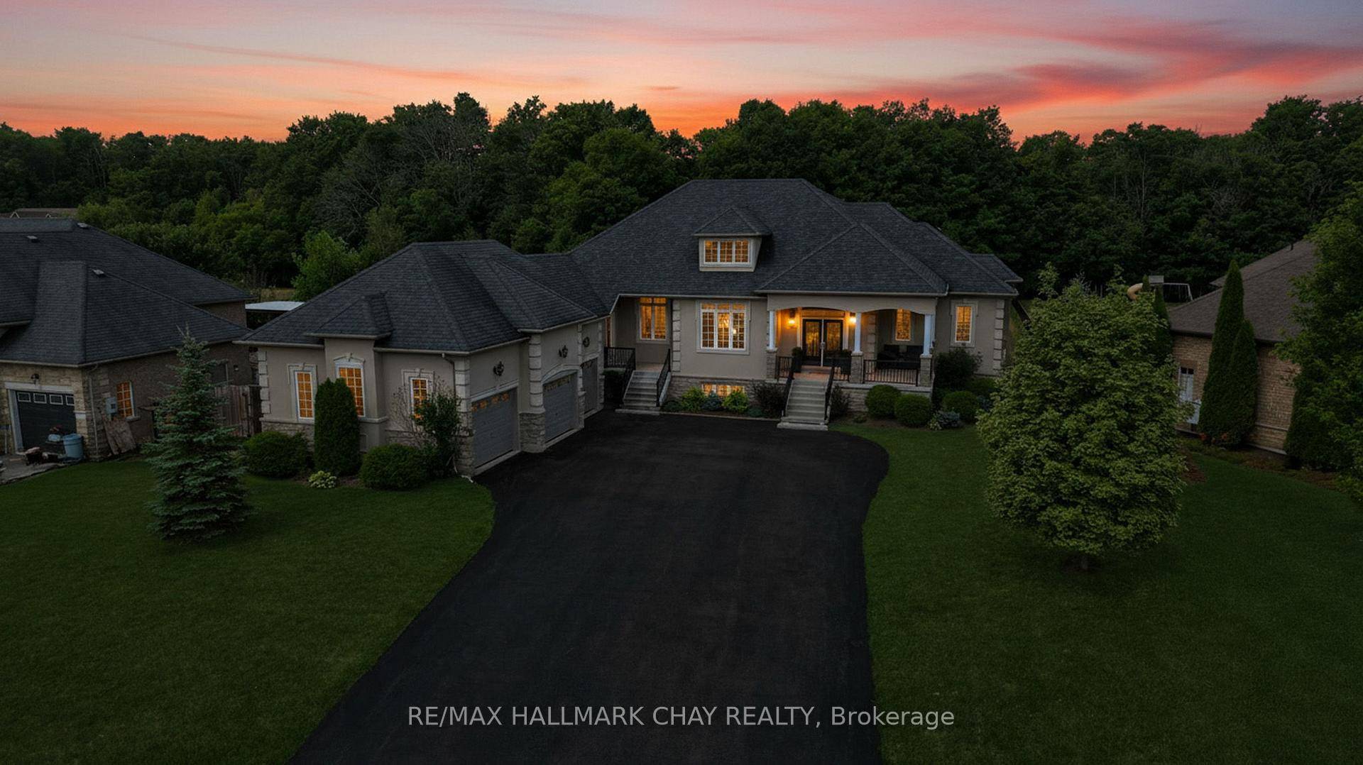 Step into this impressive raised bungalow in Wasaga Beach's prestigious Wasaga Sands Estates, set on a rare ravine lot surrounded by expansive estate properties.