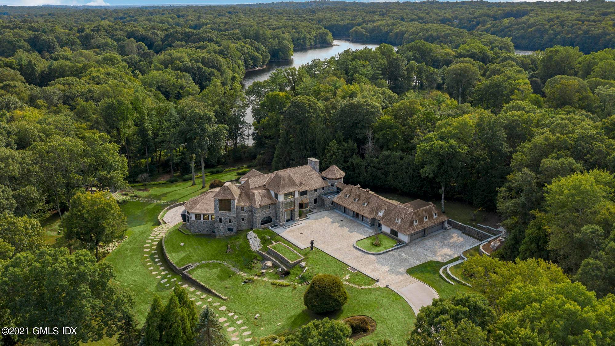 Perched on 10 waterfront acres of lush grounds and mature landscaping, this architectural masterpiece is unrivaled in the juxtaposed design of hand cut stone and modern design.