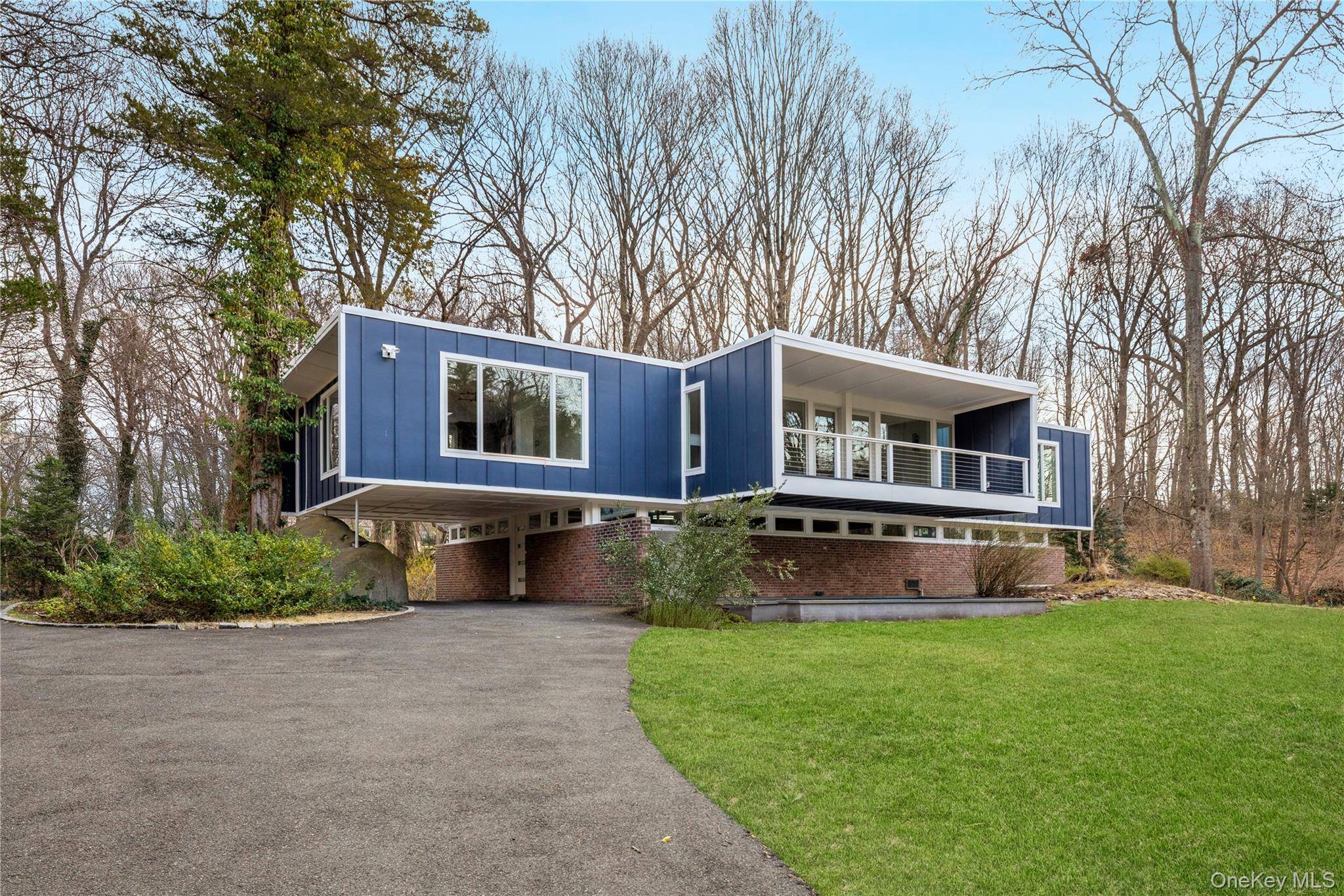 Experience architectural artistry at its finest at 25 Wood Road, a spectacularly reimagined residence originally designed by the legendary I.