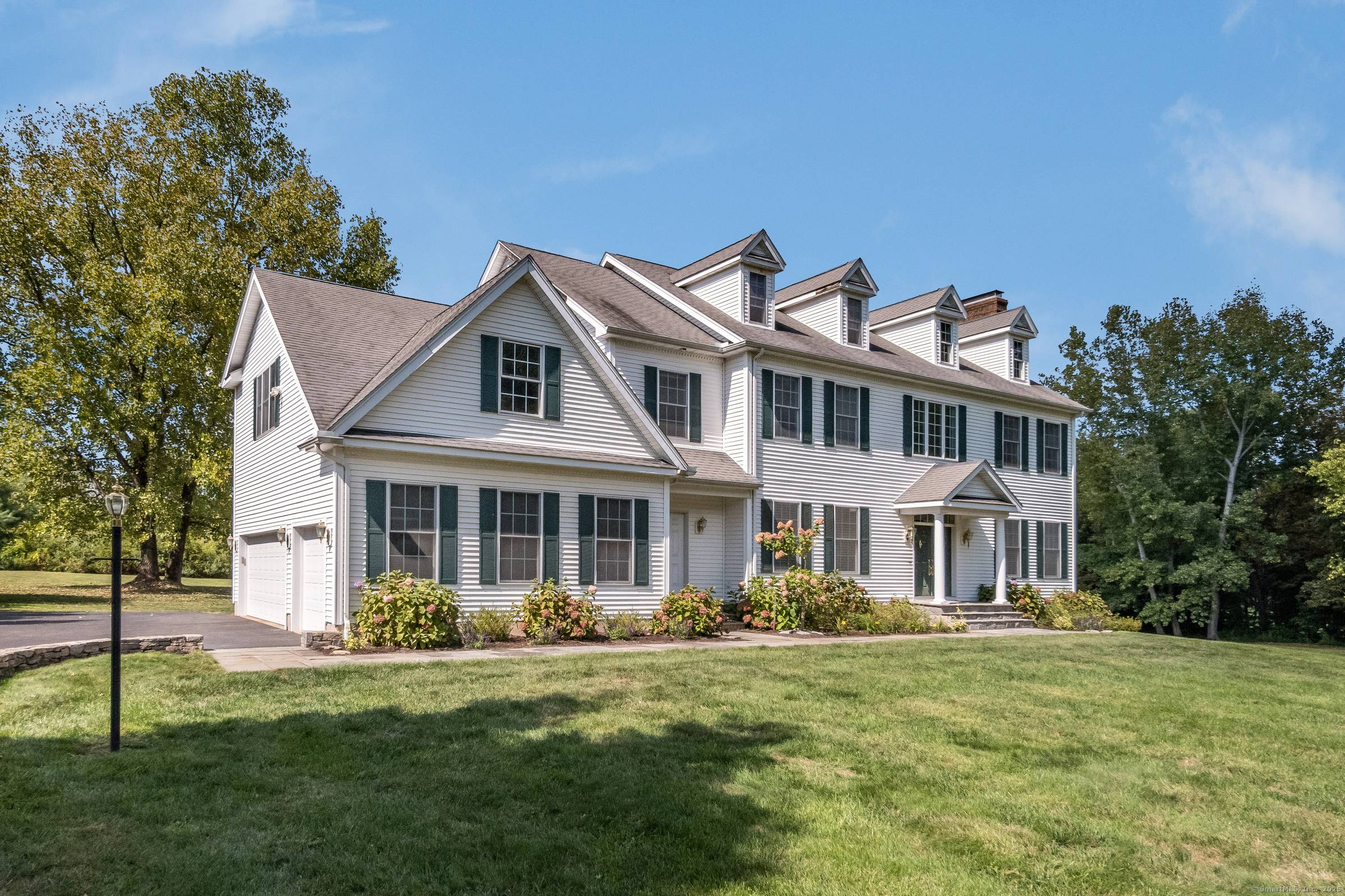 This Colonial style home, custom built in 2004, features beautiful, oversized windows so the home enjoys abundant natural light in every room in the house.