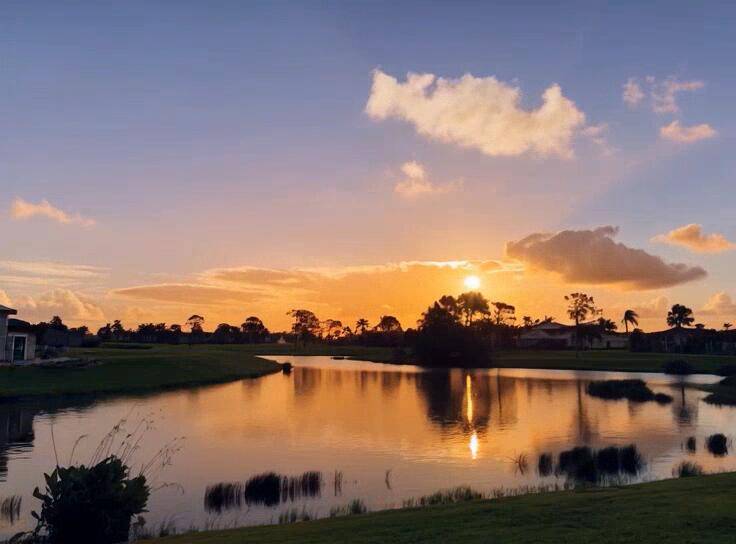 The sunrise reflects on the waters of this long view lakefront building site, with tee to green views of the Palmer 5th golf hole in the distance.