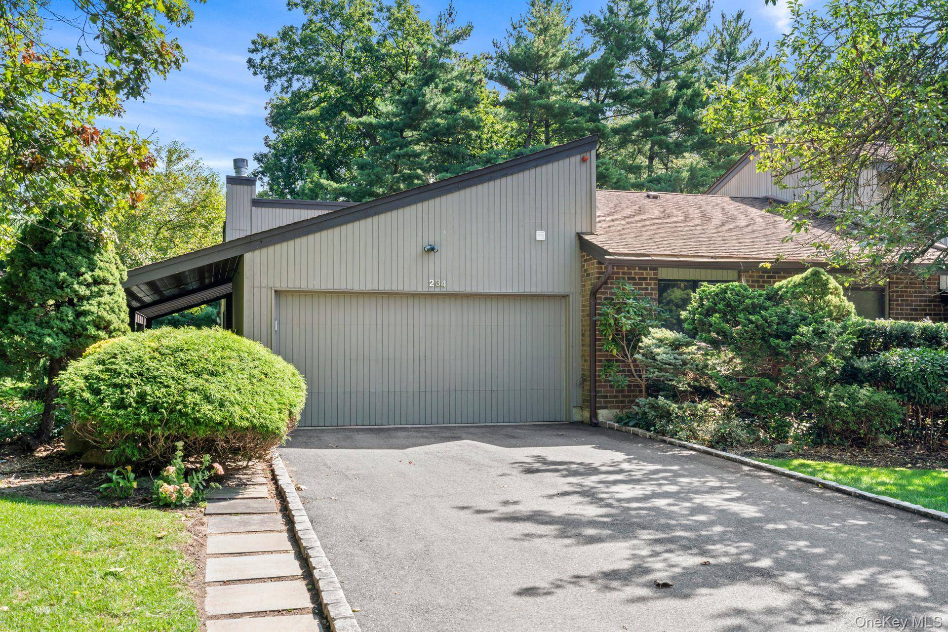 Surrounded by expansive greenery and a wrap around Trex deck, 234 Hamlet Drive is an end unit California Ranch ' with three bedrooms and two and a half baths.