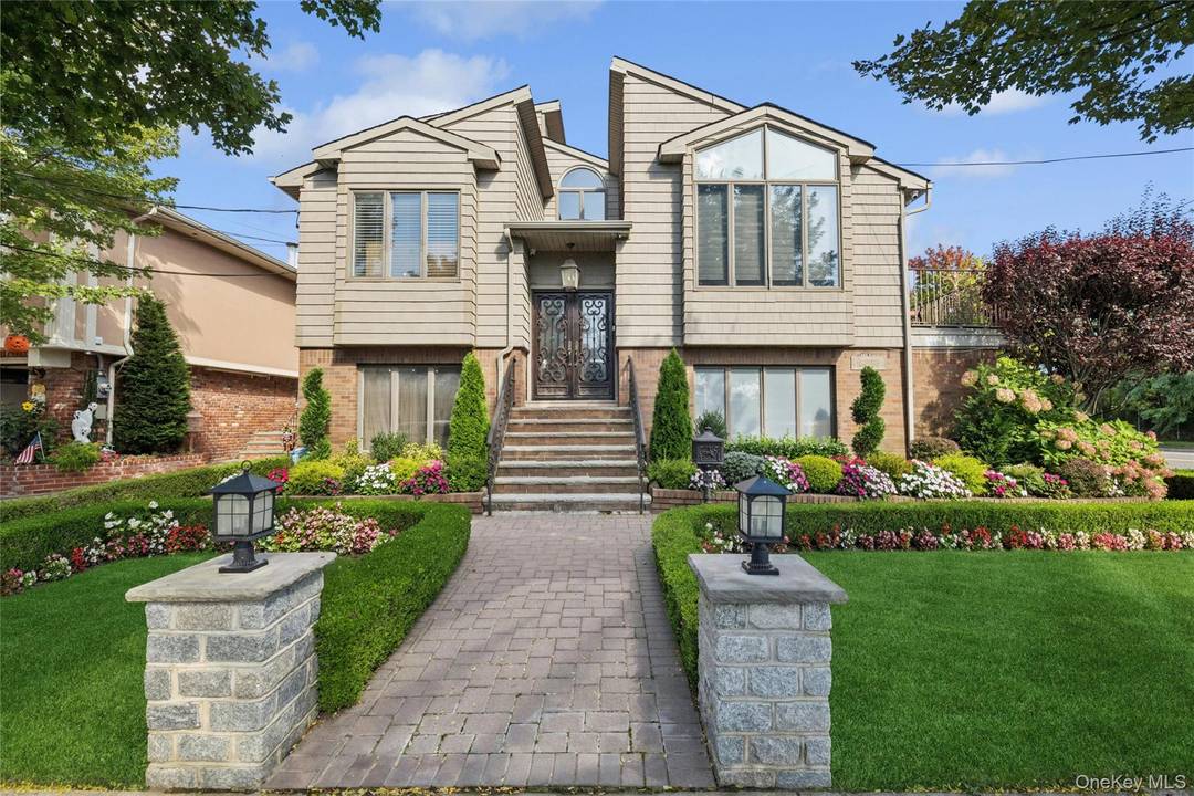 Welcome to 164 53 85th Street a spectacular six bedroom, three full bath mother daughter home, completely remodeled and fully renovated with a designer s touch at every corner.