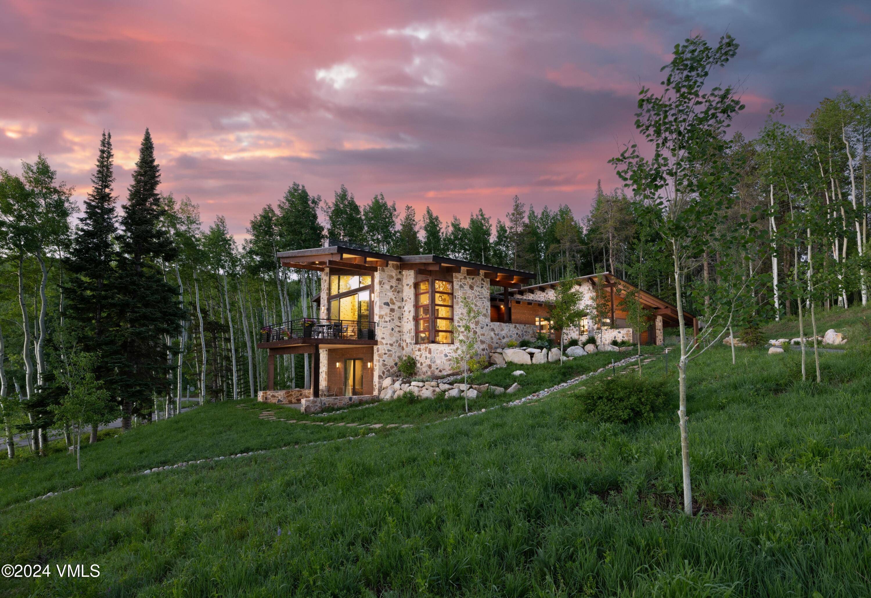 Nestled in an idyllic and serene aspen grove within the prestigious gated community of Mountain Star, this captivating home embodies contemporary warmth, elegance and privacy.