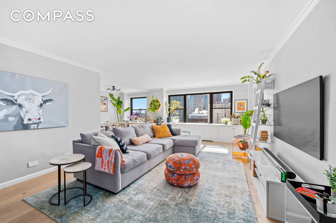 High floor three bedroom with a private balcony overlooking the East River.