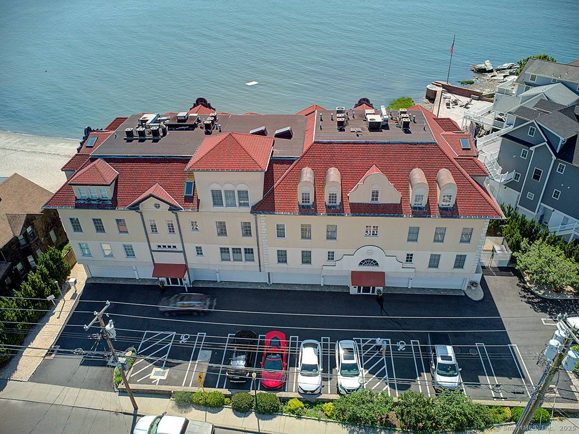 Experience the ultimate in coastal living w this stunning direct waterfront condominium, offering breathtaking views of Long Island Sound your very own private sandy beach.