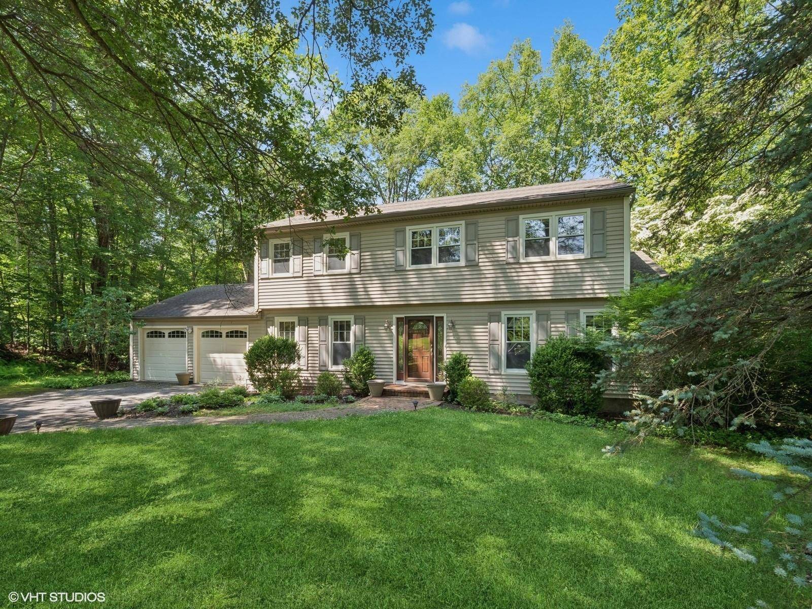 Set on a peaceful, dead end street, this classic Colonial offers a rare blend of privacy, livable space, and natural beauty.