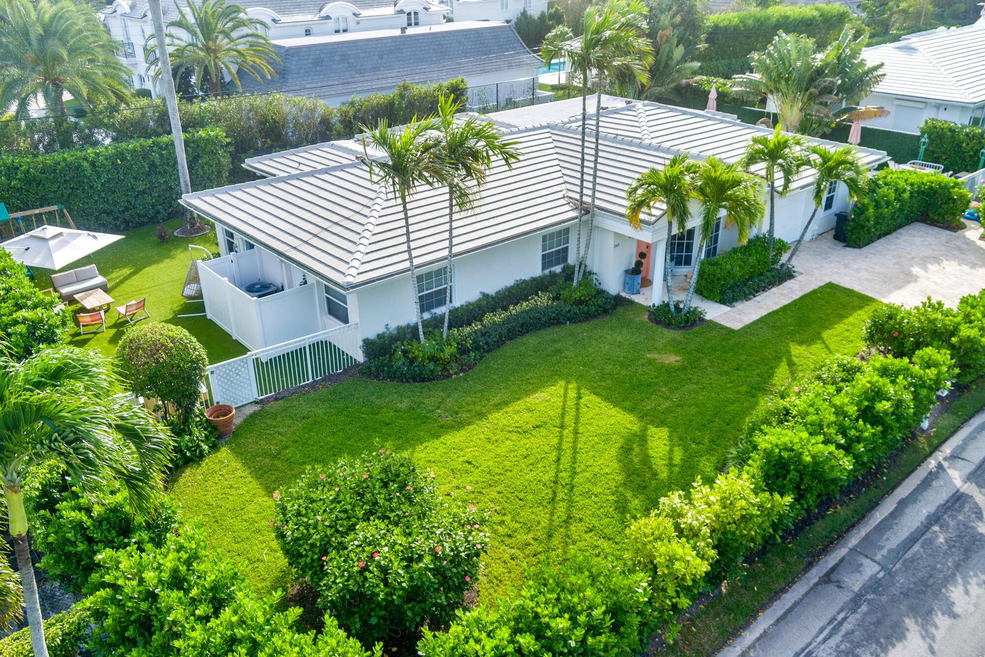 One story Bermuda style residence featuring split floor plan encompassing spacious primary suite plus three additional bedrooms for guests.