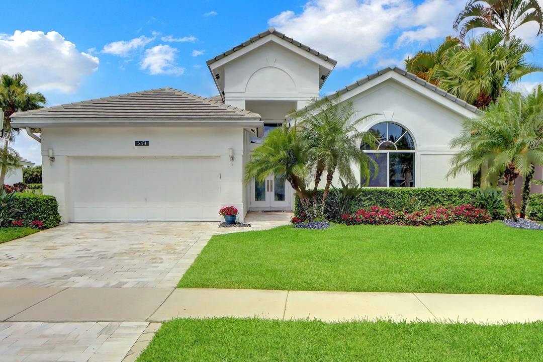 Panoramic lake and golf course views fill this contemporary one story retreat.