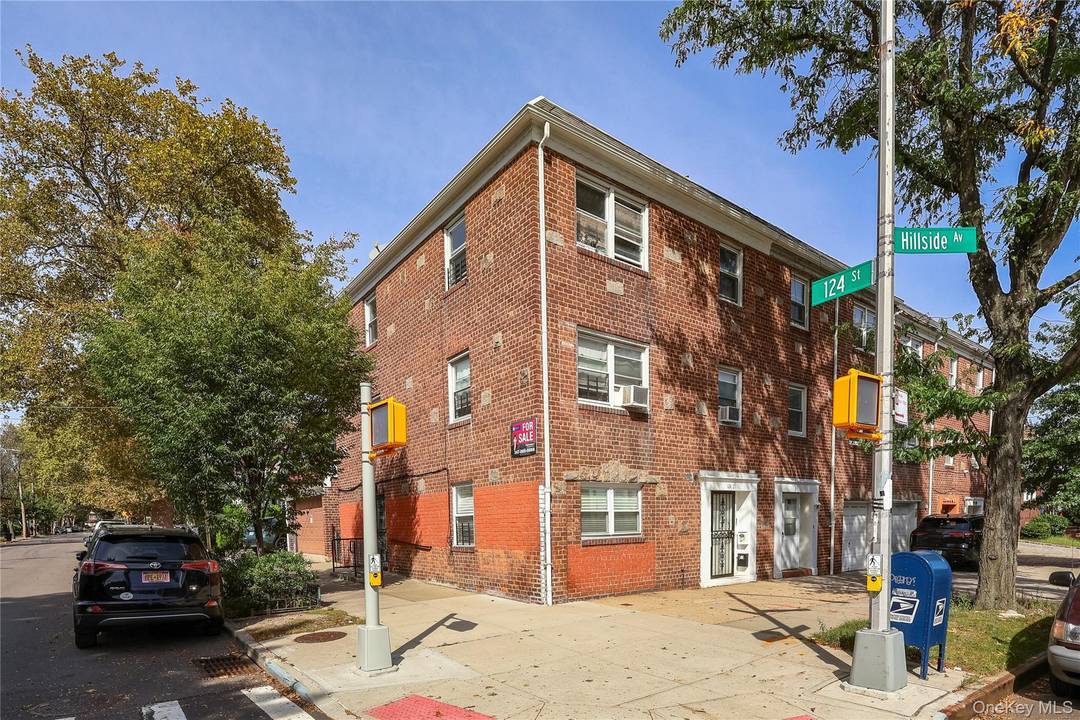 Welcome to 124 01 Hillside Avenue, a legal three family brick corner property situated in the vibrant Kew Gardens neighborhood of Queens.