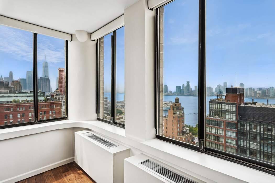 Welcome to 22D at The Memphis Downtown a high floor West Village home with sweeping views of the Statue of Liberty, Hudson River, and downtown skyline from both the window ...