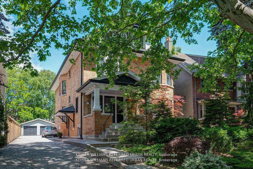 Stately Edwardian brick home with a lush front garden and landscaped backyard.