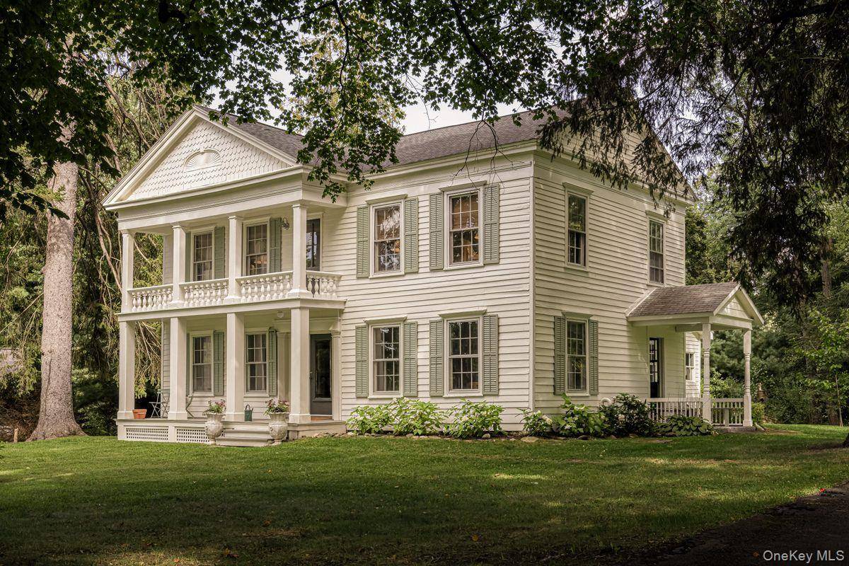 A fabulous example of early Hudson Valley architecture, this c1840 Greek Revival farmhouse sits on three rolling green acres of meadow and gardens.