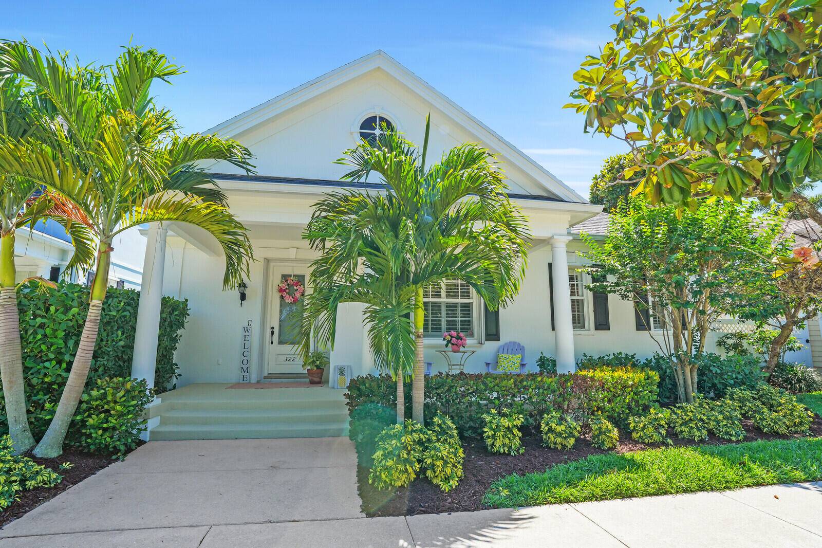 Bright and inviting, this courtyard style home in NewHaven at Abacoa offers serene preserve views from the welcoming front porch.