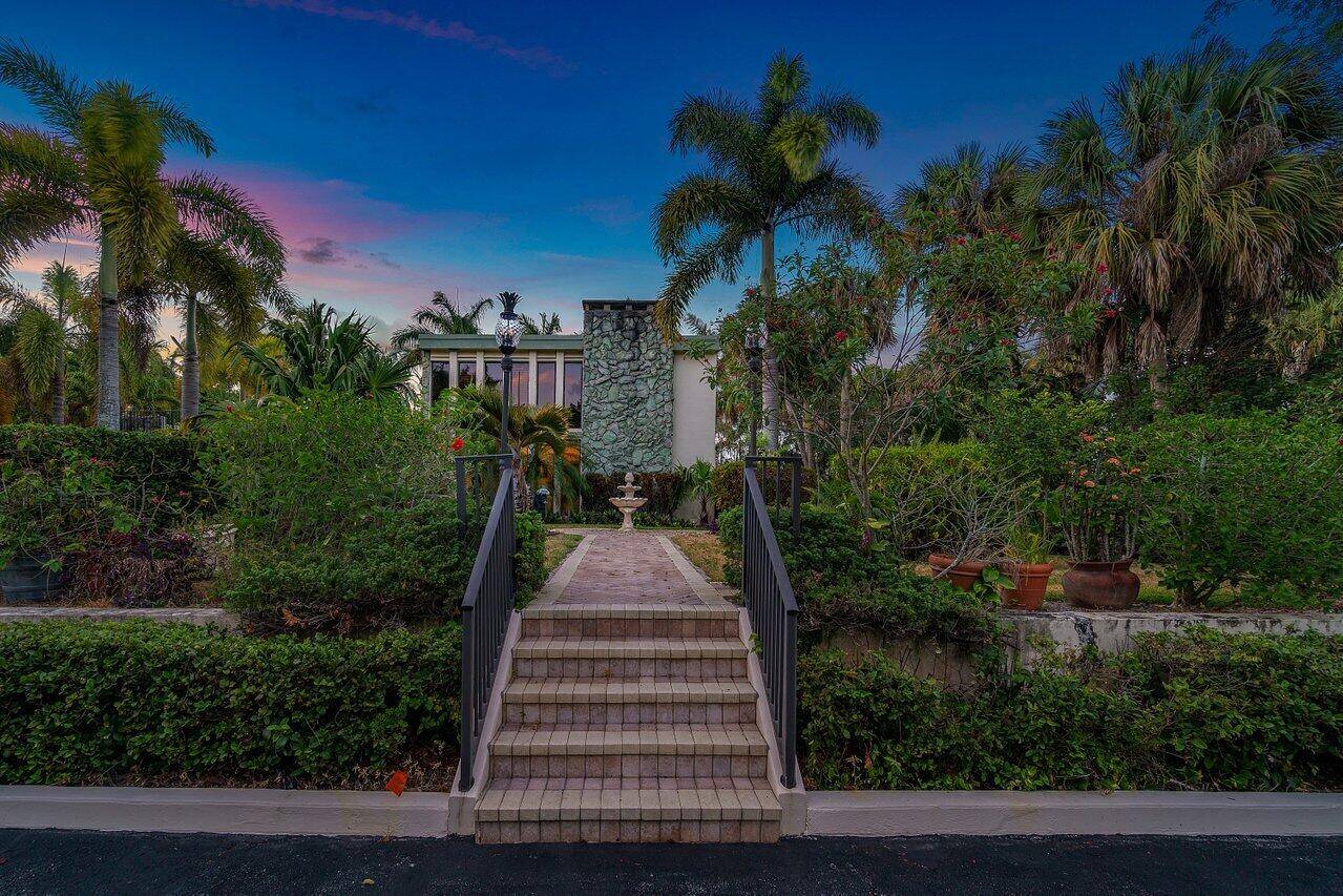 2. 5 ACRES OF MANICURED ZEN GARDENS 1080 SQ FT FULLY EQUIPPED OUT BUILDING ORIGINAL OWNER CANAL FRONT, SALT WATER HEATED POOL HOME !