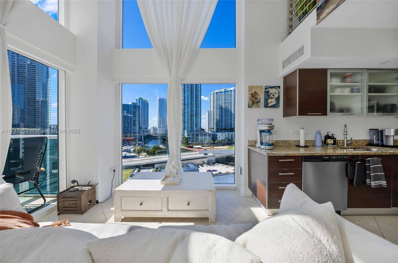 Stunning 2 bed, 2 bath corner loft in the heart of Brickell featuring floor to ceiling windows, 20ft ceilings, and 2 separate balconies with beautiful water and sunset views.
