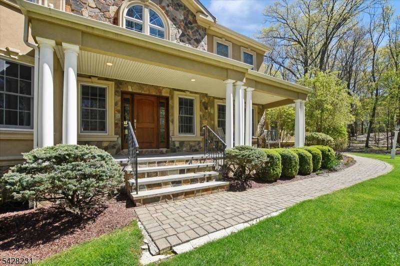 An elegant stone and stucco residence offering refined luxury and exceptional craftsmanship throughout.