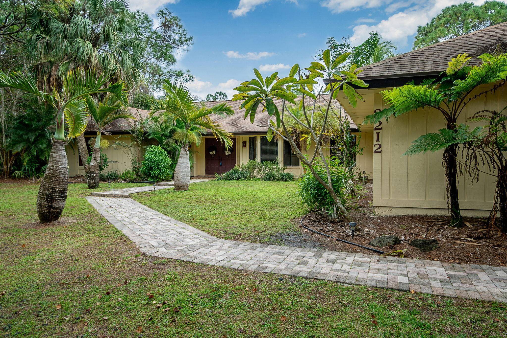 Rare Find CANALFRONT 4 2 2 in Palm Beach Country Estates PLUS there is a County 30' Easement on the West Side for added space CORNER LOT !