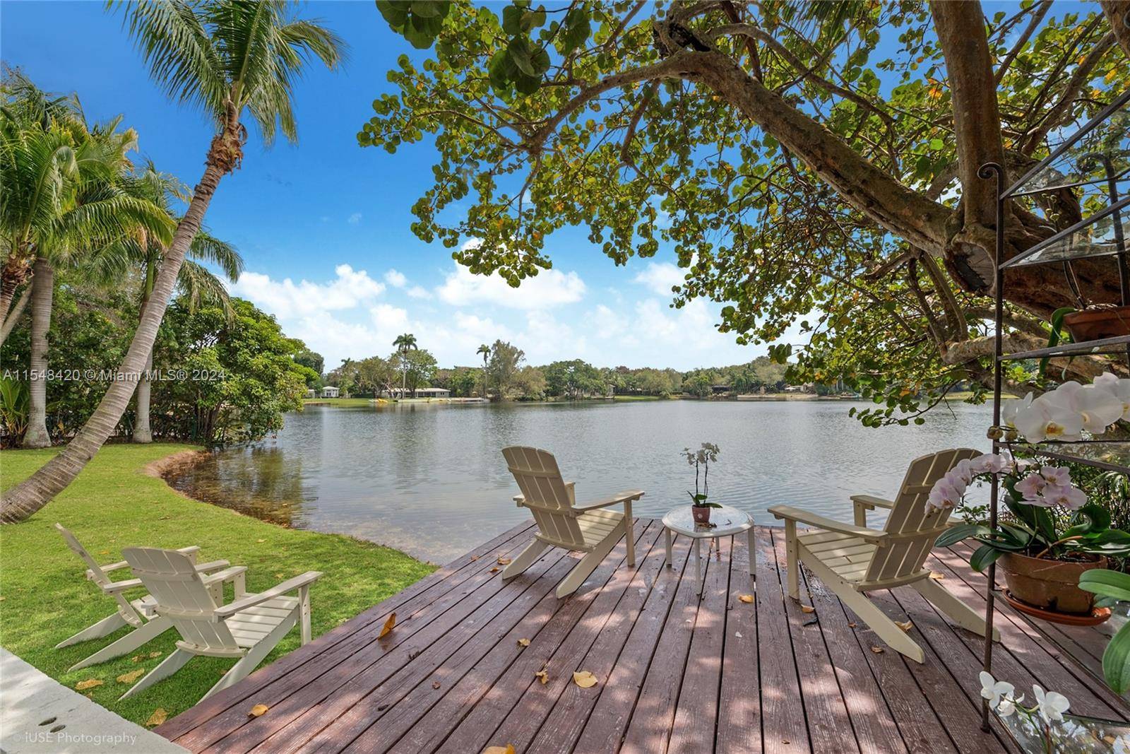 Privacy gates open to a deep lake front acre and private oasis in South Gables, minutes from top schools and the South Miami town center.