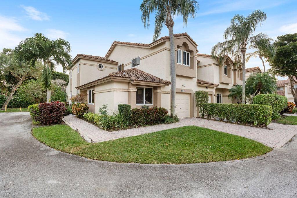 Experience Luxury and Modern Conveniences with this beautifully upgraded, rarely available corner unit townhome in the prestigious Boca Pointe community.