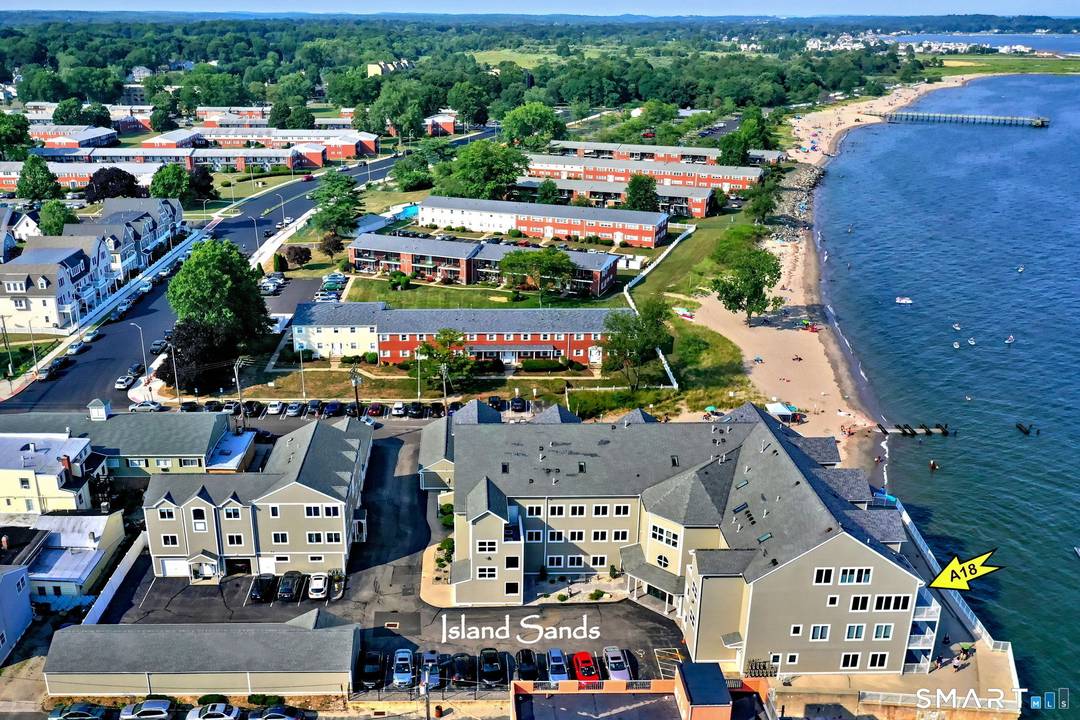DIRECT WATERFRONT CONDO Private sandy beach and expansive waterside patio.