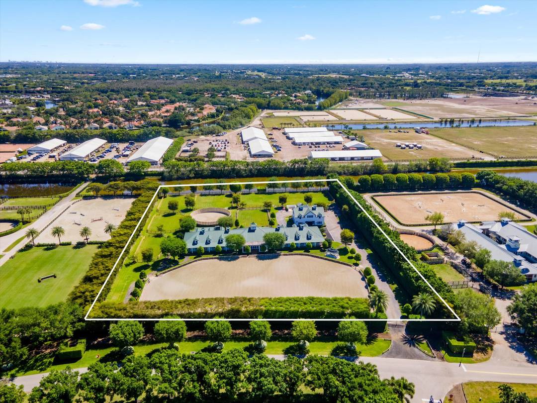 This top tier equestrian estate located in Wellington's Grand Prix Village, features 24 stalls with water access, 4 grooming stalls, 6 large grass paddocks, and a 150x270 Martin Collins arena.