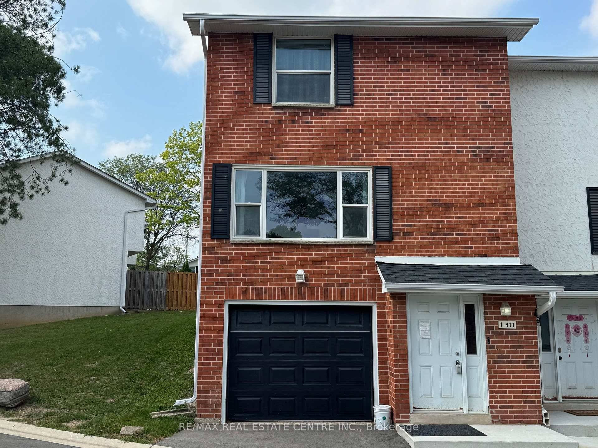 Clean 3 bedroom, 2 washroom end unit townhouse with garage and private backyard backing onto treed parkette and nestled in desirable Waterloo area.