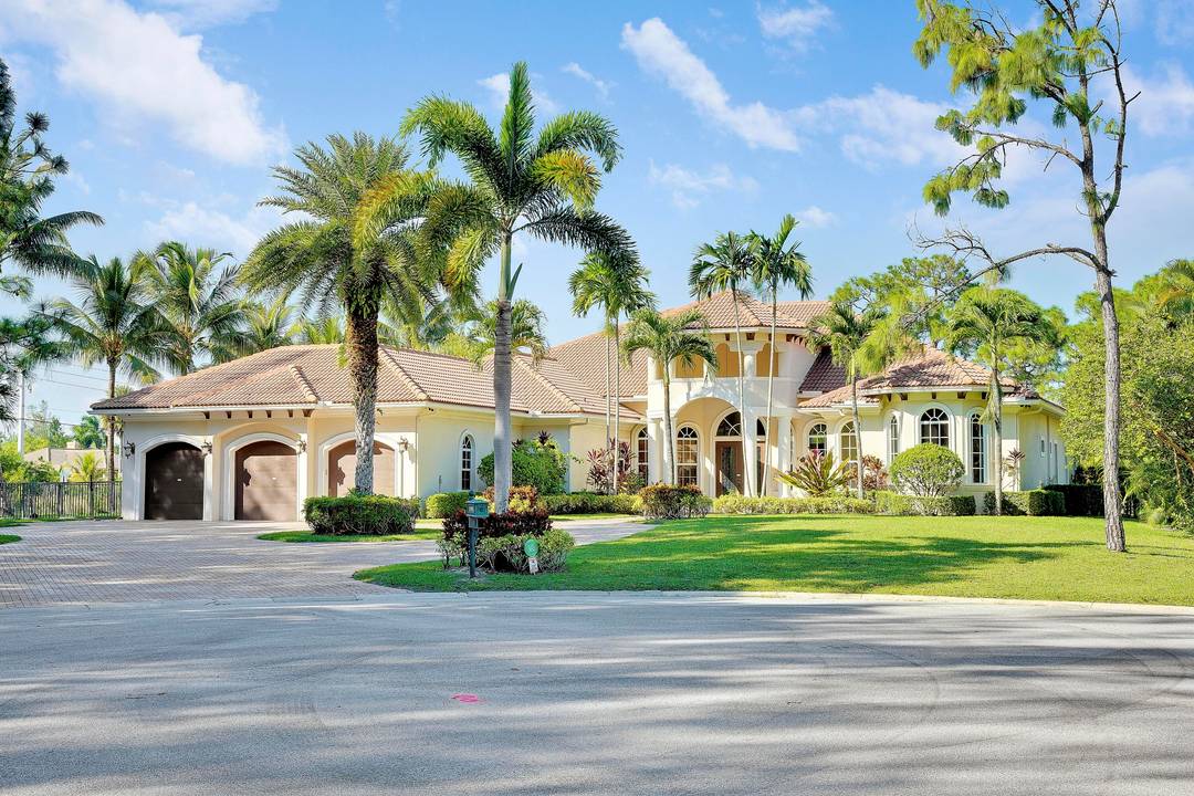 LOVELY ESTATE HOME located in PALM BEACH GARDENS offering a BEAUTIFUL ONE ACRE WATERFRONT LOT with expansive LAKE and GOLF COURSE VIEWS situated on a CUL DE SAC with a ...