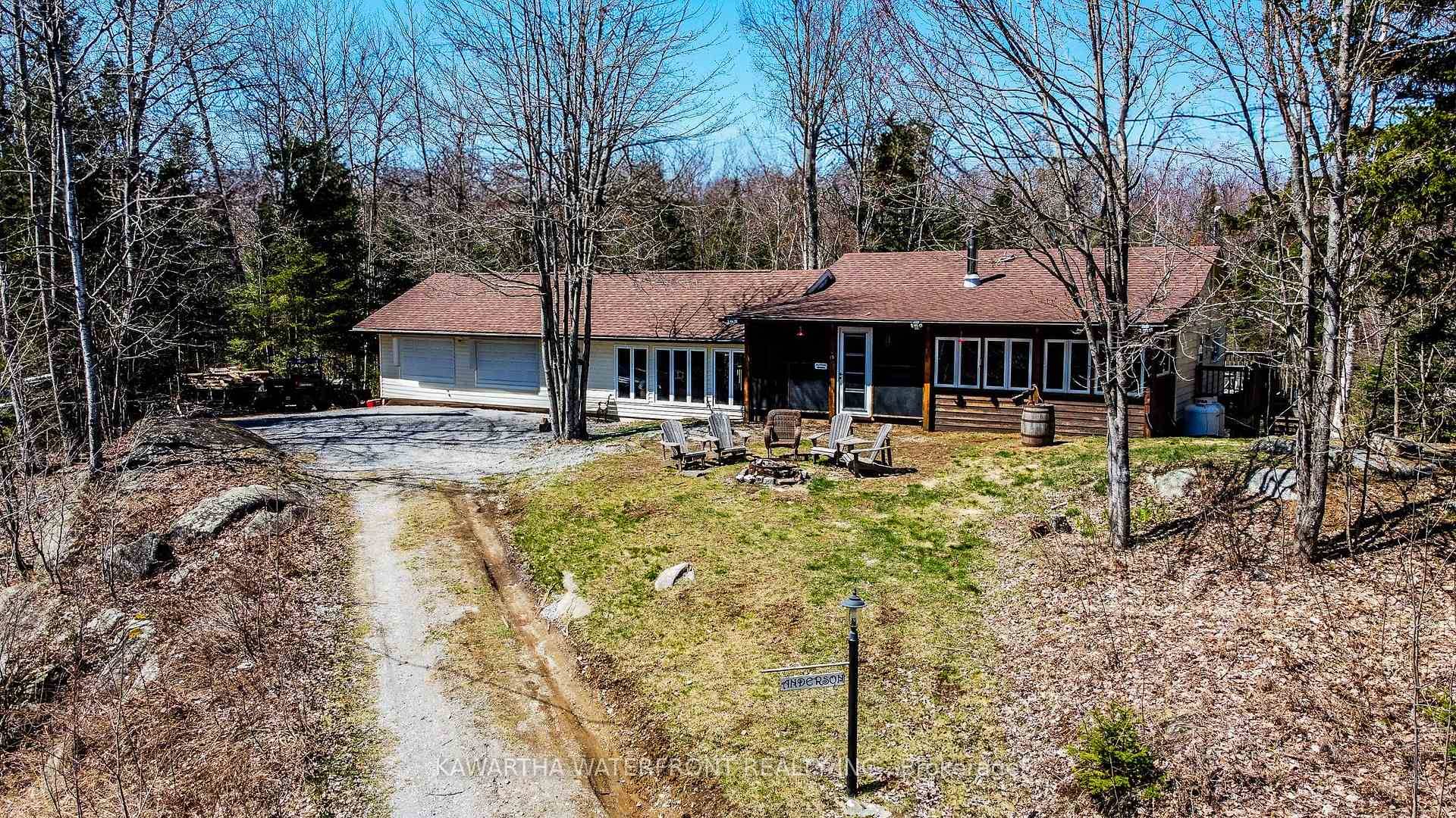 Perched atop a gentle hill, this charming cottage or home offers breathtaking views of the shimmering lake.