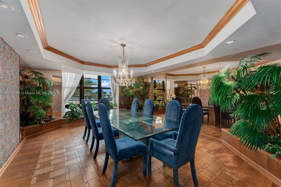 Corner unit in immaculate condition showcasing beautiful millwork, rich wood, and a Retro Miami Glam style, with stunning Intracoastal views overlooking the pool.